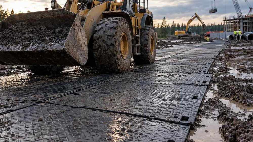 Heavy equipment used to create materials for the plastics network through paved access to wet and sticky land